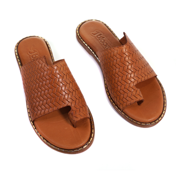 Flat slide sandals with an open toe and a loop around the great toe